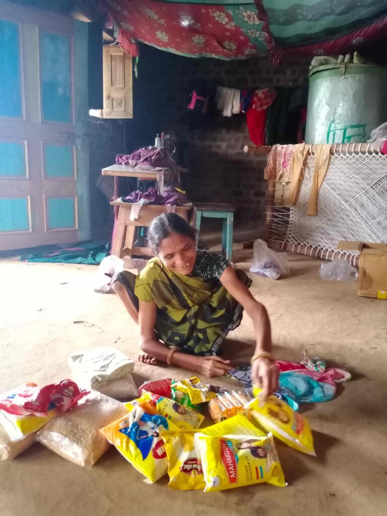 Gora Didi receives her ration at home - Samaj Pragati Sahayog - SPS